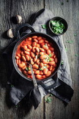 Hot baked beans made of fresh tomatoes and herbs