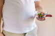 fattening food, high-calorie snack. weight loss, dietary, balanced nutrition. overweight man eating sugary candies