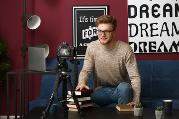 Wall Mural - Young male blogger recording video at home