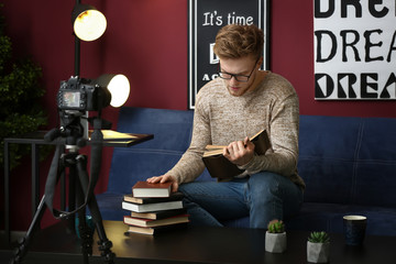 Wall Mural - Young male blogger recording video at home