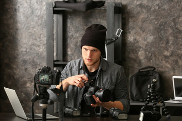 Wall Mural - Young male blogger recording video at home