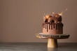 © Pixel-Shot - Sweet chocolate cake with sparklers on table against color background
