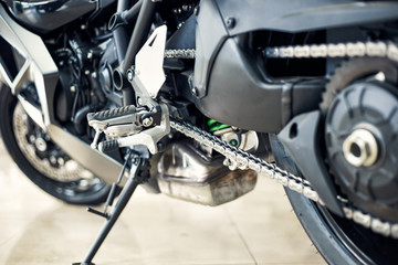 View of the back of a motorcycle with an emphasis on the chain.