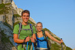 © helivideo - PORTRAIT: Cute hiker couple smiles after reaching the mountaintop in the Alps.