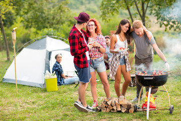 Two hugging couples in love near barbecue.