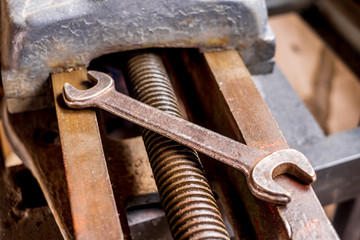 Rusty old vintage wrench on industrial equipment isolated 