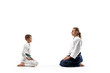 © master1305 - Man and teen boy at Aikido training in martial arts school. Healthy lifestyle and sports concept. Fightrers in white kimono on white background. Karate men with concentrated faces in uniform greetings