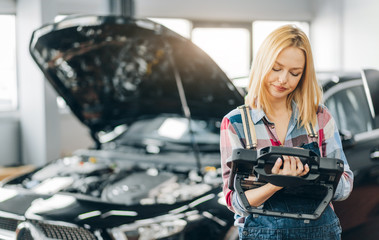 Wall Mural - attractive lovely girl controlling the systems in modern automobiles. close up photo