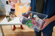 © estradaanton - Recycling. Mixed electronic waste in plastic contaner close-up. Responsible man is protecting environment while sorting the waste at home