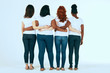 © alfa27 - Rear view of diverse multi ethnic women with different body size and hairstyle standing in row dressed in the same casual manner, hugging together on white background.