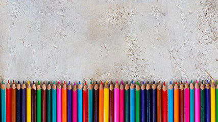 Mady Pecils of different colors on cement grey background Kid, Children, Education, Art, Drawing, Graphic, Copy space, Empty, three fingers grip, neuro psychology skills, right whtiring position