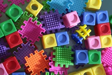 Pile of colored toy bricks isolated on white background 