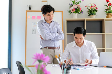 Wall Mural - two young asian man designer website applications consulting and planning work together. job trainin