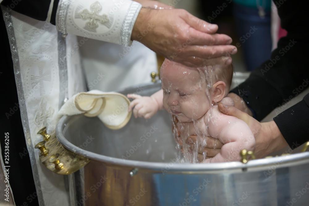 Photo Stock Priest pours water on the infant at baptism. Orthodox rite of baptism. Acceptance of ...
