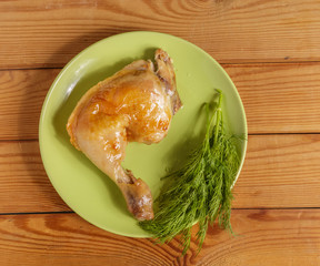 Fried chicken ham and dill on a plate on the table.