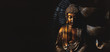 Golden Gautama Buddha statue with a black background.