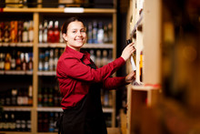 Picture Of Smiling Woman In Wine Shop