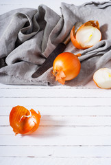 Poster - onion cutting on white wooden background