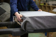 © MexChriss - Closeup of a young man in a furniture factory who puts together one part of the sofa