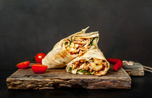 Burrito Wraps With Chicken And Vegetables On A Cutting Board, Against A Background Of Concrete, Mexican Shawarma