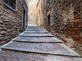 Fototapeta Uliczki - stone steps on narrow medieval street in Bergamo