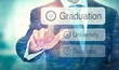© Duncan Andison - A business man selection a button on a futuristic display with a Graduation concept written on it.