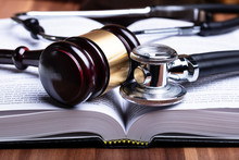 Stethoscope And Mallet Over Opened Law Book