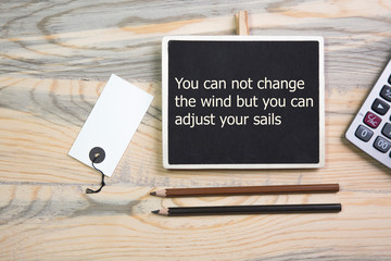 The text Motivational quote You can not change the wind but you can adjust your sails
