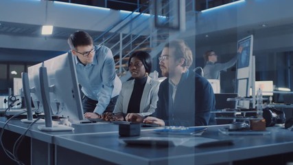 Two Electronics Development Engineer Working on Computer, Talks with Project Manager. Team of Professionals Use CAD Software for the Modern Industrial Engineering Design. 