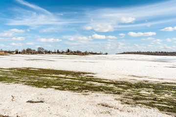 thawed patch on the field, snowy outdoor soccer field in spring low season