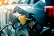© Koonsiri - Hand refilling the car with fuel at the refuel station