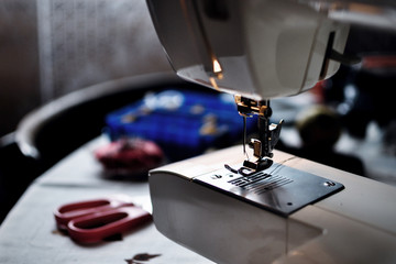 electric sewing machine on table of country house, close-up 