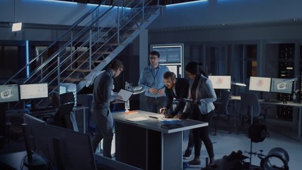 Leinwandbilder - Diverse Team of Electronics Development Engineers Gather at the Desk Working with Documents, Solving Project Problems Late at Night. Specialists Working on Ultra Modern Industrial Design. Slow Motion