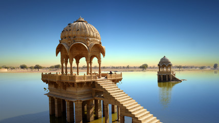 Fototapete - Gadi Sagar temple gazebo on Gadisar lake Jaisalmer, Rajasthan, India