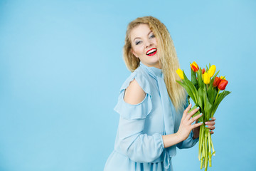 Pretty woman with red yellow tulips bunch