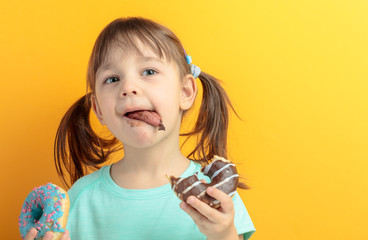 Girl in a turquoise shirt eat donuts.