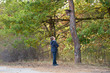 © Bolbot Visuals - A boy with blue jacket looking looking at a birdhouse on a tree in the forest