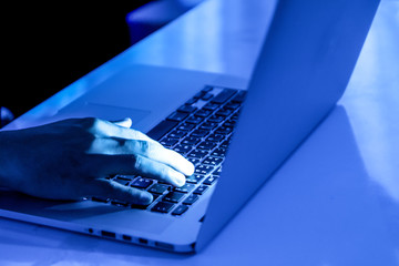 a computer programmer or hacker prints a code on a laptop keyboard to break into a secret organizati