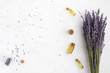 Organic cosmetic with lavender flowers and oil on white background with copy space, top view and flat lay
