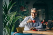 © cherryandbees - happy senior businessman on coffee break in cafe bar.