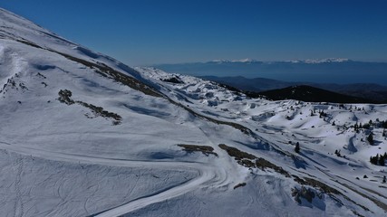 Aerial drone photo of iconic snowed mountain of Parnassus with popular ski resort covered up in snow and unique nature, Voiotia, Greece