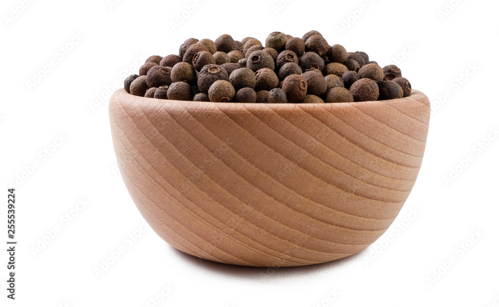 allspice or Jamaican pepper in wooden bowl isolated on white background. Spices and food ingredients. - obrazy, fototapety, plakaty 