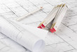 © Shawn Hempel - Rolls of architectural blueprint house building plans with pencil and folding ruler on blueprint background