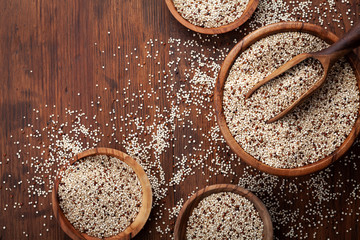 Wall Mural - Mixed quinoa in bowl on wooden kitchen table top view. Healthy and diet superfood product.