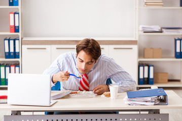 Wall Mural - Man having meal at work during break