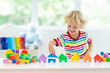 © famveldman - Kids toys. Child building tower of toy blocks.