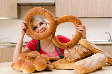 Young female baker working in kitchen 