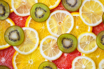 Wall Mural - Fresh sliced mixed citrus fruits like background, concept of healthy eating, dieting, top view. Background.