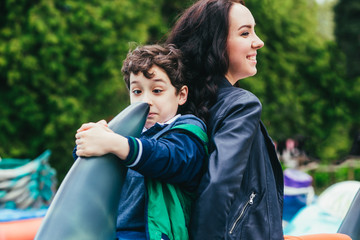 Son and mother in the amusement park.