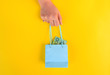  female hand hold little shopping bag with australian dollar money